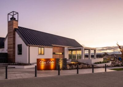 An outside view of Paragon Eatery's building from behind showing the Olive Estate sign